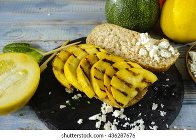 Healthy Vegetarian Veggie Sandwich With  Grilled Yellow Squash Zuccihi, Mushrooms, Paprika, Salad, Feta Cheese On Blue Table Top