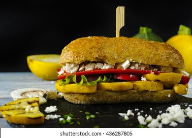 Healthy Vegetarian Veggie Sandwich With  Grilled Yellow Squash Zuccihi, Mushrooms, Paprika, Salad, Feta Cheese On Blue Table Top