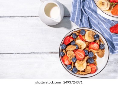 Healthy vitamin diet summer breakfast. Cereal Multigrain  flakes with yogurt or milk and strawberries, blueberries, on kitchen table copy space - Powered by Shutterstock