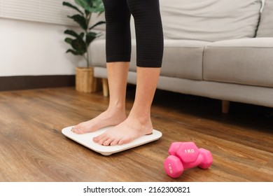 Healthy And Weight Loss Concept, Young Asian Woman Stand On Weighing Scales To Checking Her Weight.