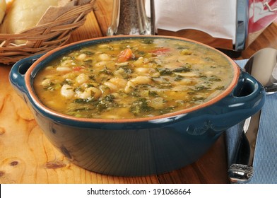 A Healthy White Bean And Kale Soup With Dinner Rolls