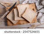 Healthy wholemeal bread slices on wooden table. Top view