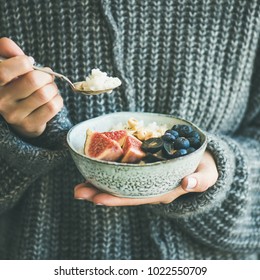 Healthy Winter Breakfast. Woman In Woolen Sweater Eating Rice Coconut Porridge With Figs, Berries, Hazelnuts, Square Crop. Clean Eating, Vegetarian, Vegan, Alkiline Diet Food Concept