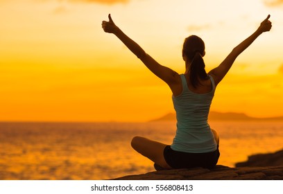 Healthy woman celebrating during a beautiful sunset. Happy and Free. - Shutterstock ID 556808413