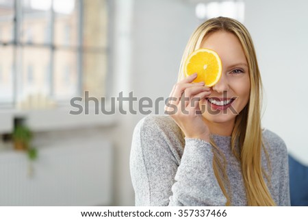 Similar – Image, Stock Photo Young blonde woman holding orange leaf