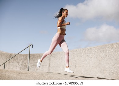 Healthy woman on morning run. Female in fitness wear on running workout.