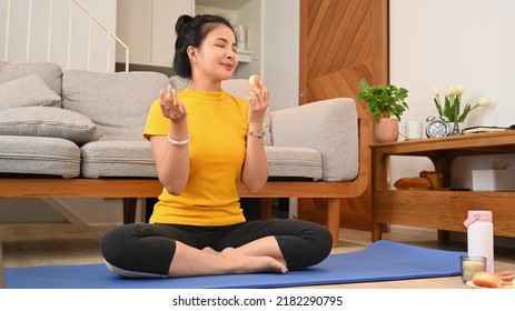 Healthy Woman Practicing Yoga On Mat, Trying To Resist Temptation