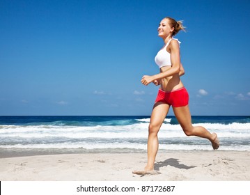 Healthy Woman Running On The Beach, Doing Sport Outdoor, Freedom, Vacation, Heath Care Concept With Copy Space Over Natural Blue Background