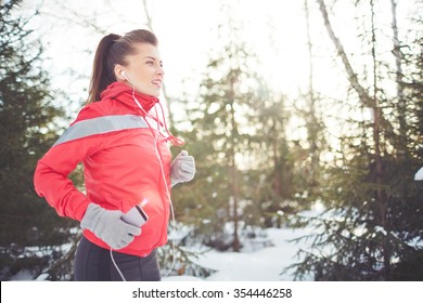 Healthy Woman Running In Winter Park