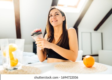 Healthy Woman In Sportswear Drinking Sweet Orange Juice Smoothie After Home Workout.Vitamin Supplement.After Exercise Shaker Meal.Weight Loss Fitness Post Work Out Diet.Organic Citrus Fruit