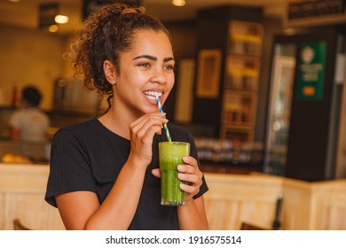healthy woman taking her green detox juice. - Shutterstock ID 1916575514