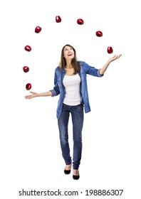 Healthy woman throwing apples, isolated over a white background