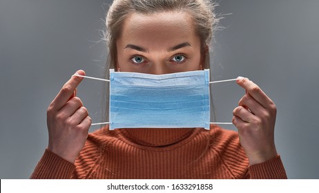 Healthy woman using medical protective mask to health protection and prevention from flu virus, epidemic and infectious diseases