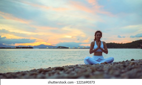 Healthy Women Practicing Yoga. Sitting In Lotus Pose Meditation Outdoors Concentrating Breathing Asana Yoga.Easy.
Landscape View Sky On Morning Outdoor Near Sea, Concept For Exercising, Health Care