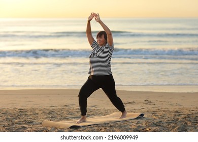 healthy yoga middle ages woman workout yoga pose on mat on the sandy beach at sunrise, benefits of natural environments for physical, spiritual, healthy, relaxing concept. - Powered by Shutterstock