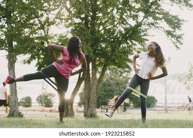 Healthy young african women outdoors in morning park. Friends training. - Powered by Shutterstock