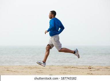 Healthy Young Black Man Jogging At The Beach