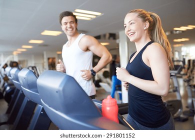 Healthy Young Couple Doing Running Exercise on Treadmill Device Inside the Gym with Happy Facial Expressions. - Powered by Shutterstock