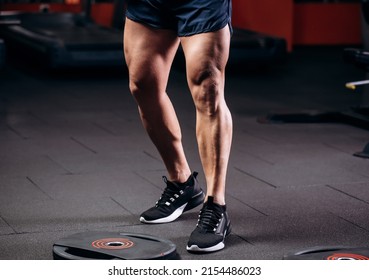 Healthy Young Man Standing Strong In The Gym And Flexing Legs Close Up