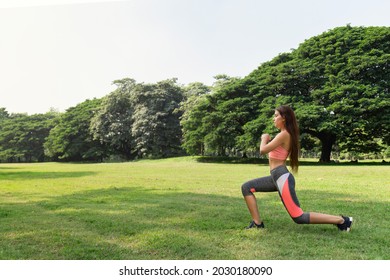 Healthy Young Teenage Girl Stretching Arms Workout And Warmup Before Fitness Training Session In The Park At Sunday Morning. Life After Covid.