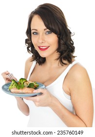 Healthy Young Woman Eating Salmon And Vegetables