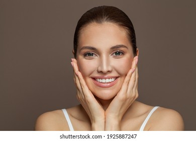 Healthy Young Woman Smiling On Brown Background. Skincare And Facial Treatment Concept