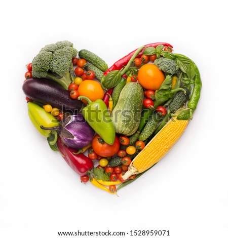 Healty diet concept. Heart shape frame of fresh vegetables on white background