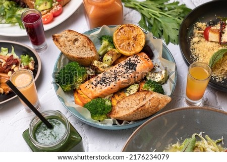 Healty smoked salmon fish with vegetables served on a white table