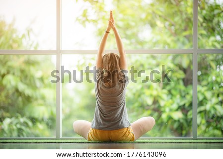 healty women doing yoga in practice at home, time to exercise and relax fitness at home