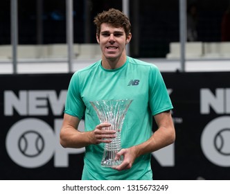 Heampstead, NY - February 17, 2019: Reilly Opelka Of USA Holds Winner Trophy After Defeating Brayden Schnur Of Canada At Final Of New York Open ATP 250 Tournament At Nassau Coliseum