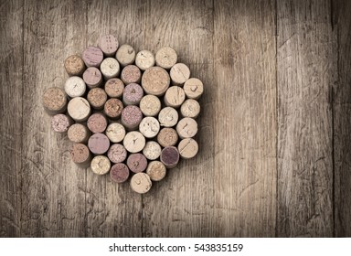 Heap of assorted wine corks on wooden background. with copy space