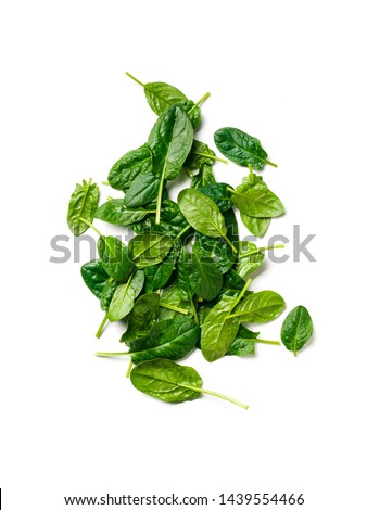 Heap of baby spinach leaves. Fresh green baby spinach isolated on white with clipping path. Top view or flat lay. Vertical.