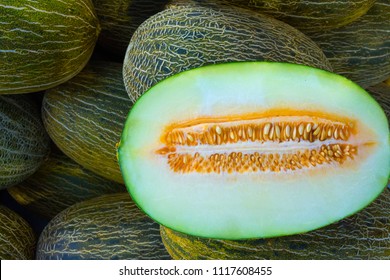 Heap of Big Ripe Organic Green and Yellow Spanish Frogs Skin Melons Mediterranean Farmers Market. Viivid Colors. Summer Harvest. Vitamins Superfoods Healthy Diet Concept. Sunlight Flecks. Close up