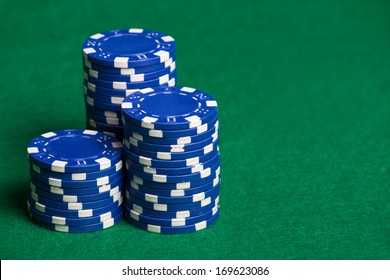 Heap Of Blue Poker Chips On The Green Table