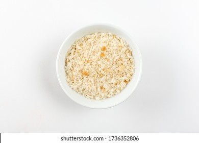 Heap of Bread Crumbs in white ceramic bowl. Top View. Crushed Rusk Bread Crumbs or Panko Isolated.