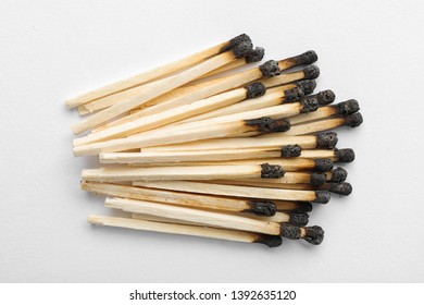 Heap Of Burnt Matches On White Background, Top View