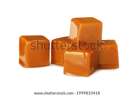 Heap of caramel candies on white background