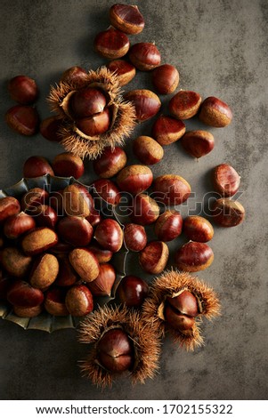 Heap of chestnuts on rusty background 