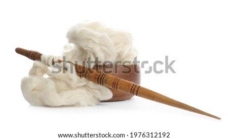Heap of clean wool with wooden spindle and bowl isolated on white