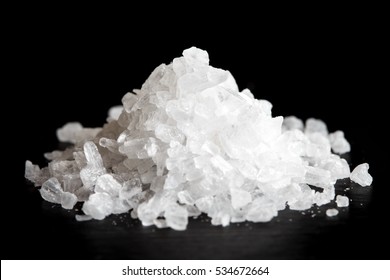 Heap Of Coarse Salt Isolated On Black.