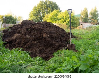 heap of compost in the farmer's vegetable garden.organic fertilizer for the soil - Shutterstock ID 2200984093