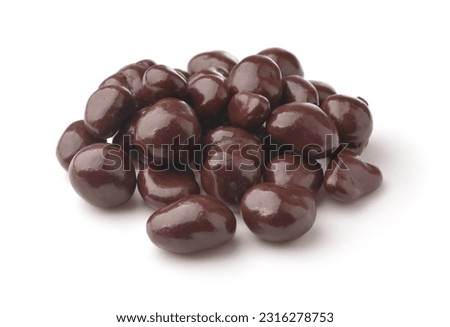Heap of dark chocolate covered raisins isolated on white