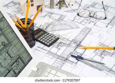 heap of design and project drawings on table background