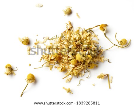 Heap of dried Chamomile tea isolated on white background; top view