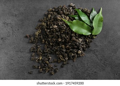 Heap Of Dried Green Tea Leaves On Grey Table, Top View