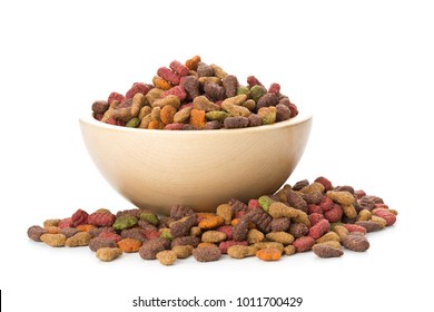 Heap of dry pet food in wooden bowl over white background