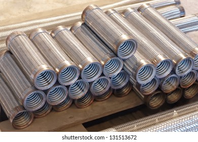 Heap Of Flexible Metal Hose In A Warehouse.