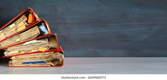 Heap of four ring binders, file folders. beat the clock,office work concept.Negative space technique, free copy space.