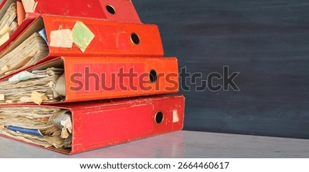 Heap of four ring binders, file folders. beat the clock,office work cpncept.Shallow depth offield. Negative space technique, free copy space.