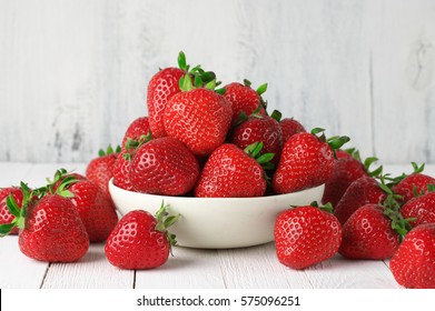 Heap Of Fresh Strawberries In Ceramic Bowl On Rustic White Wooden Background. 